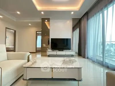 Luxurious modern living room with elegant decor and large windows offering city views.