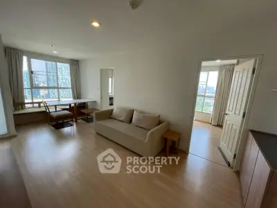 Spacious living room with modern decor and city view in high-rise apartment