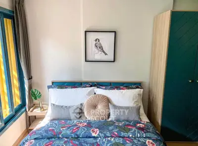 Charming bedroom with vibrant bedding and stylish decor, perfect for cozy living.