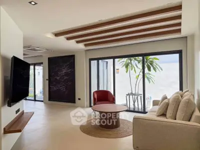 Spacious modern living room with large windows and stylish decor