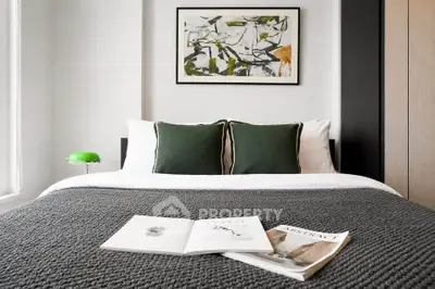 Modern bedroom with stylish decor and cozy bedding in a contemporary apartment.