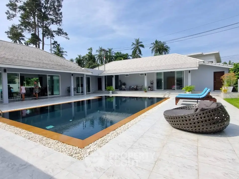 Luxurious modern villa with private pool and spacious outdoor lounge area, perfect for relaxation and entertainment.