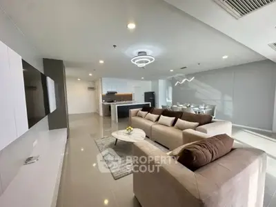 Spacious modern living room with open kitchen layout and elegant furnishings.