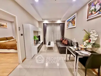 Modern living room with elegant decor and view into cozy bedroom