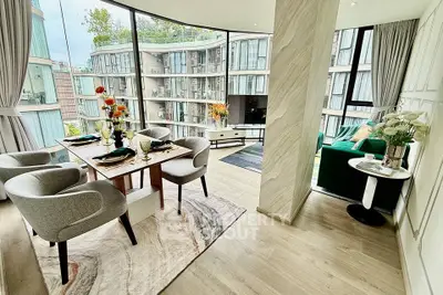 Luxurious modern living room with floor-to-ceiling windows and elegant dining area in a high-end apartment.