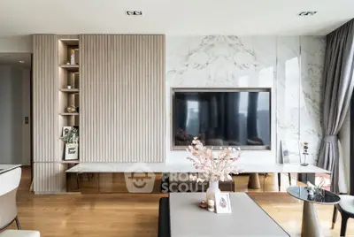 Luxurious modern living room with marble accents and large TV