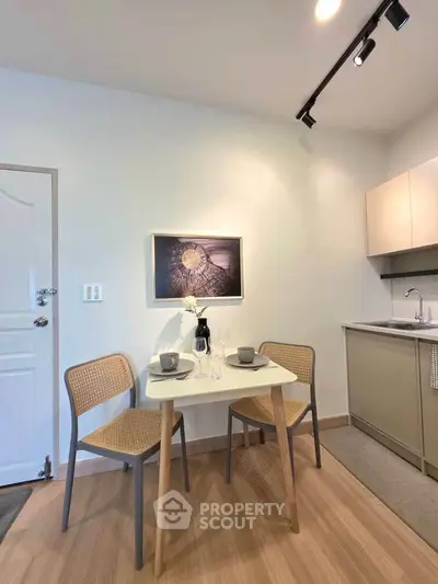 Modern kitchen with dining area featuring sleek cabinetry and stylish decor