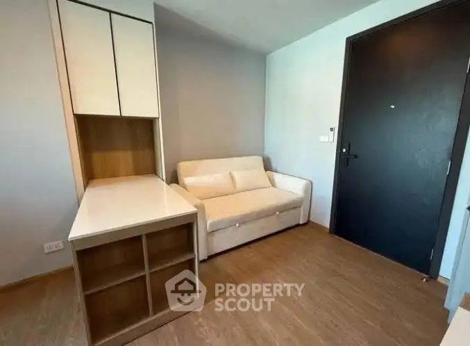 Cozy living room with modern sofa and built-in storage near entrance