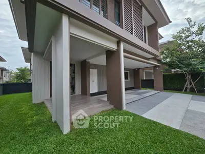 Modern two-story house with spacious driveway and lush green lawn