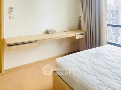 Modern bedroom with minimalist design and large window view.
