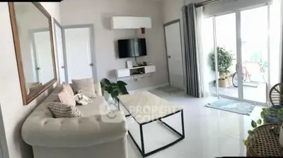 Stylish living room with modern decor, large window, and cozy seating area.