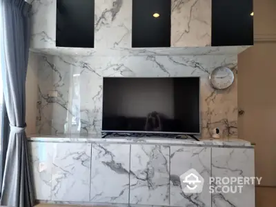 Luxurious living room with marble TV wall and modern decor