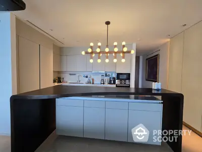 Modern kitchen with sleek design and stylish lighting fixture