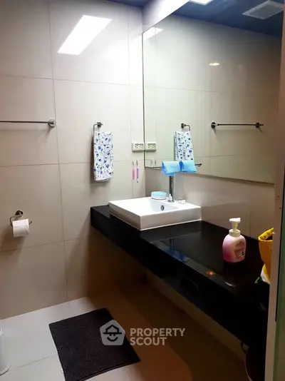 Modern bathroom with sleek black countertop and stylish sink