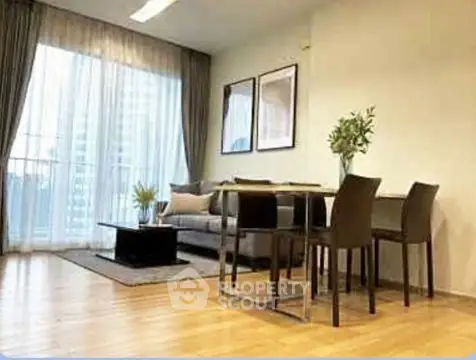 Elegant living room with modern furniture and large windows for natural light.