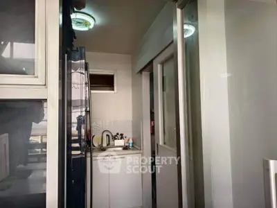 Compact kitchen area with modern appliances and sleek cabinetry