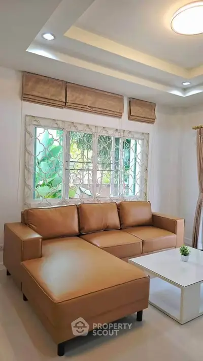 Stylish living room with modern leather sofa and elegant window view