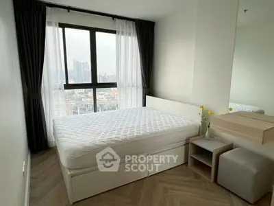 Modern bedroom with large window offering city view, featuring minimalist furniture and elegant decor.