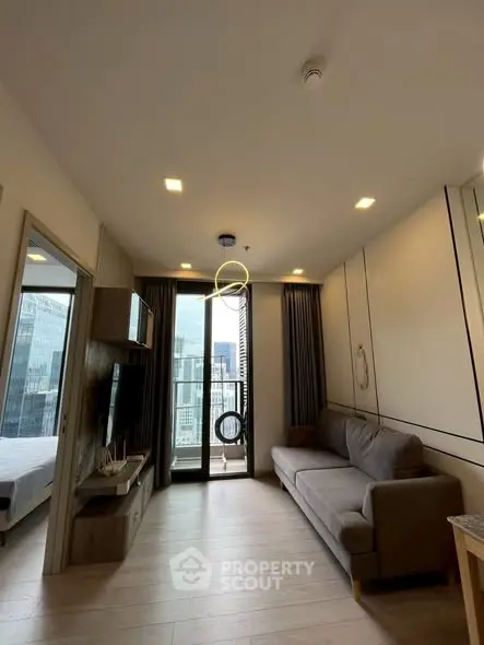 Modern living room with city view, stylish decor, and cozy ambiance in urban apartment.