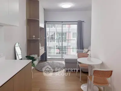 Modern living room with cozy decor and balcony view in urban apartment