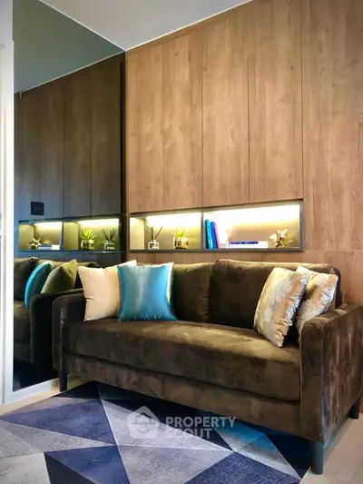 Stylish living room with plush sofa and modern decor, perfect for cozy relaxation.