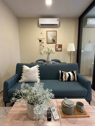 Stylish living room with modern decor, cozy sofa, and elegant dining area, perfect for urban living.