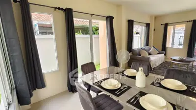 Spacious living and dining area with modern decor and ample natural light.