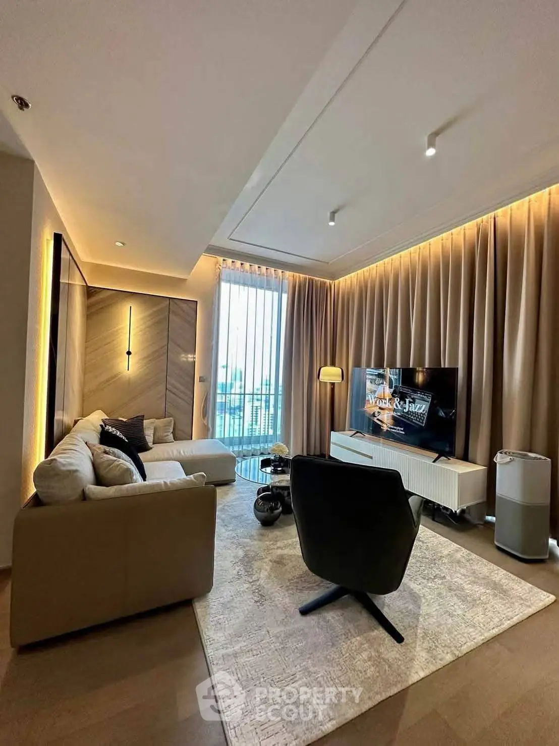 Modern living room with stylish decor and large window offering natural light.