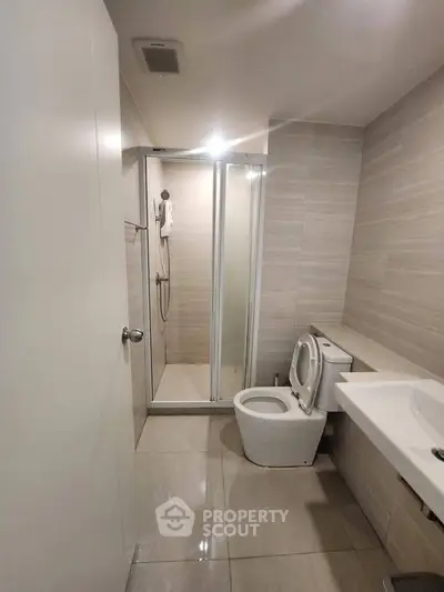 Modern bathroom with sleek shower and contemporary fixtures in a stylish apartment.