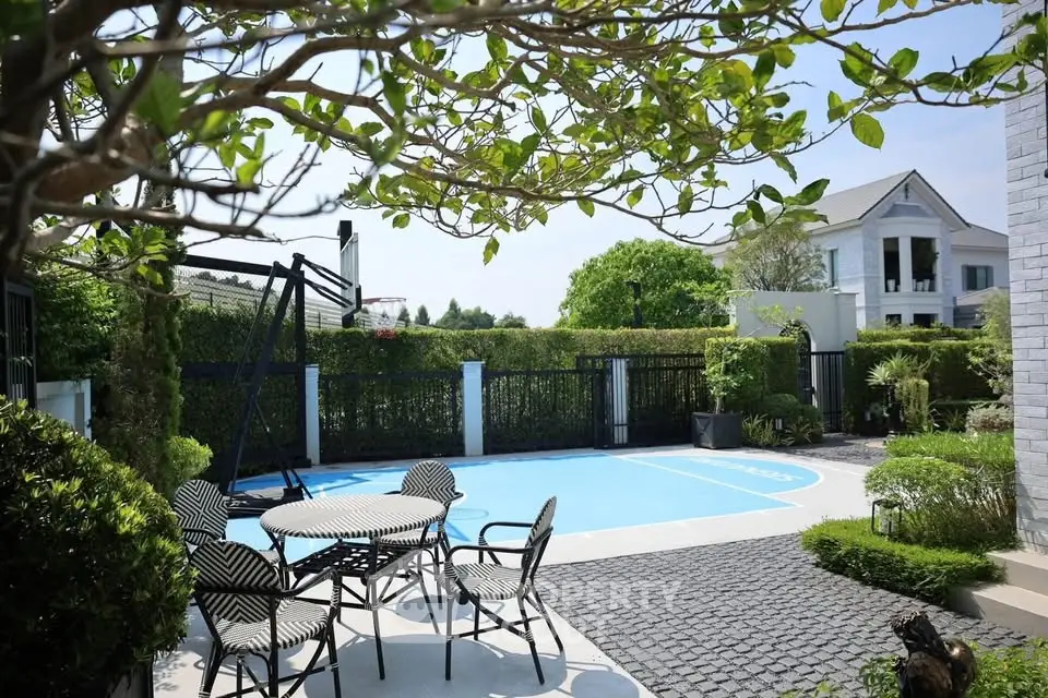Charming outdoor patio with basketball court and lush greenery in a serene residential setting.