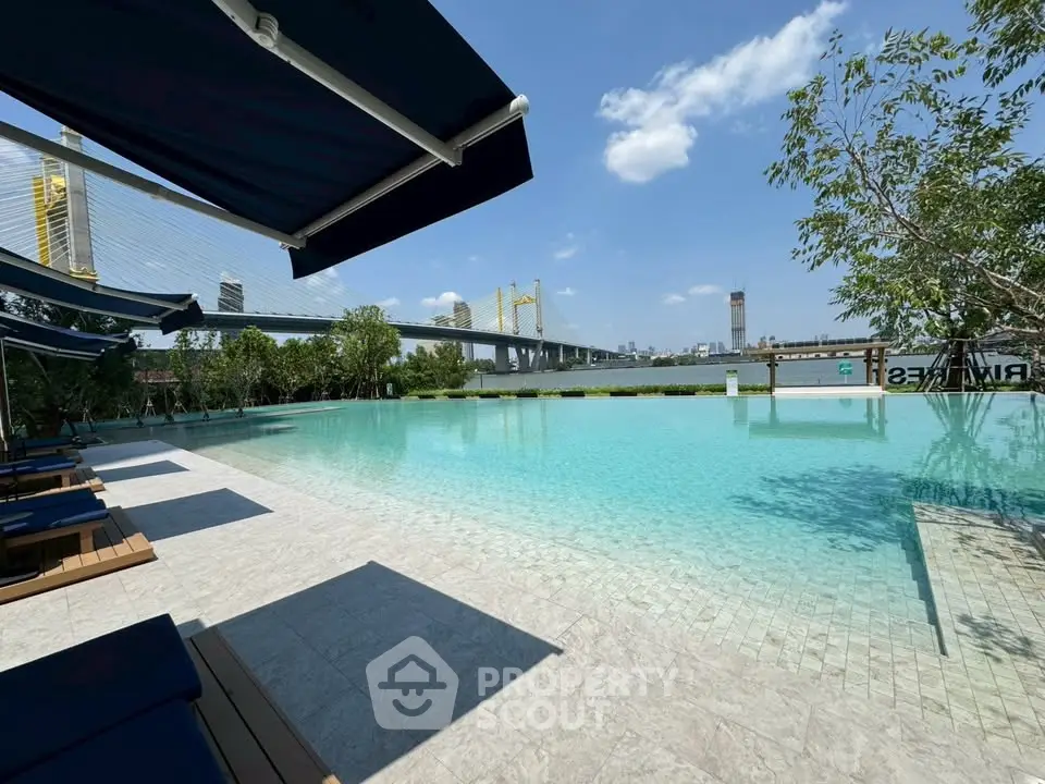 Luxurious poolside view with city skyline and bridge, perfect for relaxation and urban living.