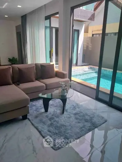 Luxurious living room with pool view and modern decor