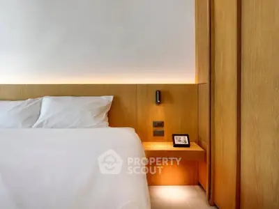 Modern bedroom with sleek wooden paneling and ambient lighting