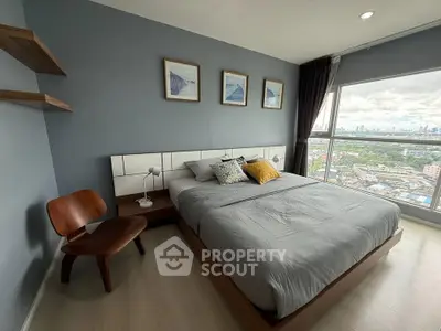 Modern bedroom with city view, stylish decor, and natural light