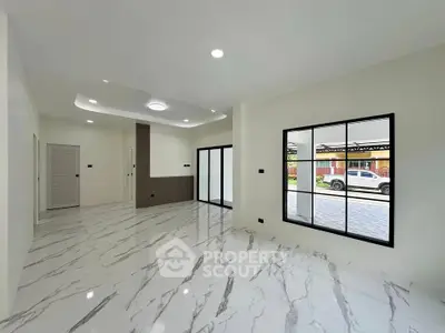 Spacious modern living room with marble flooring and large windows