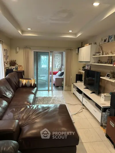 Spacious living room with leather sofa and modern entertainment center