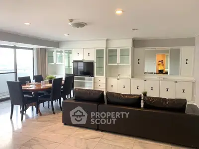 Spacious living room with elegant dining area and modern entertainment center.