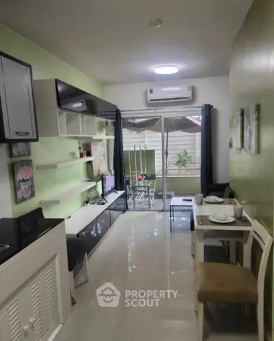 Charming living room with modern decor and access to a cozy balcony, perfect for relaxation.