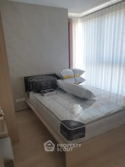 Cozy bedroom with natural light and modern decor, perfect for relaxation and comfort.