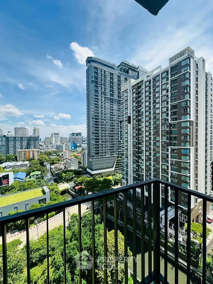 Stunning cityscape view from a high-rise balcony overlooking modern skyscrapers and lush greenery.