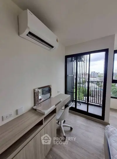 Modern study room with balcony view and air conditioning in urban apartment