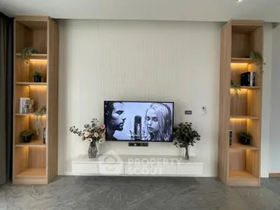 Modern living room with built-in shelves and wall-mounted TV