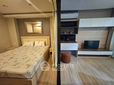 Modern studio apartment with cozy bedroom and stylish living area, featuring wooden flooring and contemporary decor.