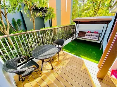 Charming balcony with seating and swing, perfect for relaxation.