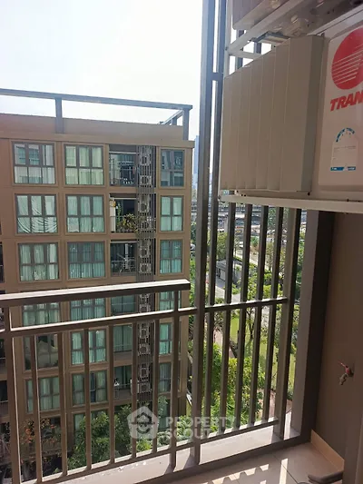 Modern apartment balcony with city view and air conditioning unit