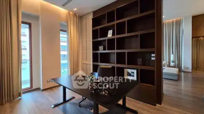 Luxurious study room with elegant wooden shelving and modern desk in upscale apartment.