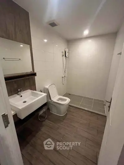 Modern bathroom with sleek fixtures and wooden flooring