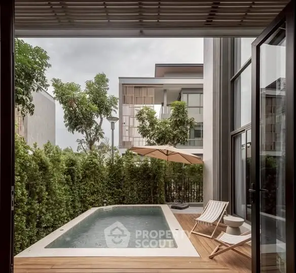 Luxurious private pool area with modern design and lush greenery, perfect for relaxation and entertaining.
