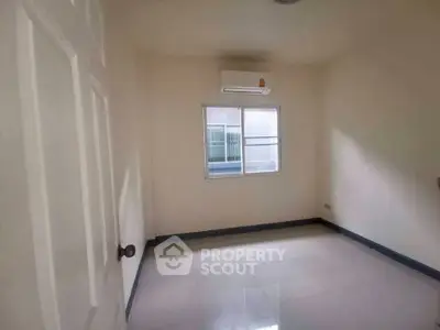 Spacious empty room with air conditioning and tiled floor, perfect for customization.