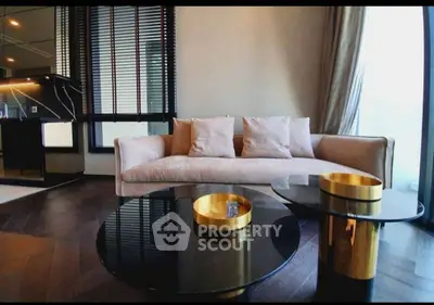 Luxurious modern living room with elegant sofa and stylish coffee tables.